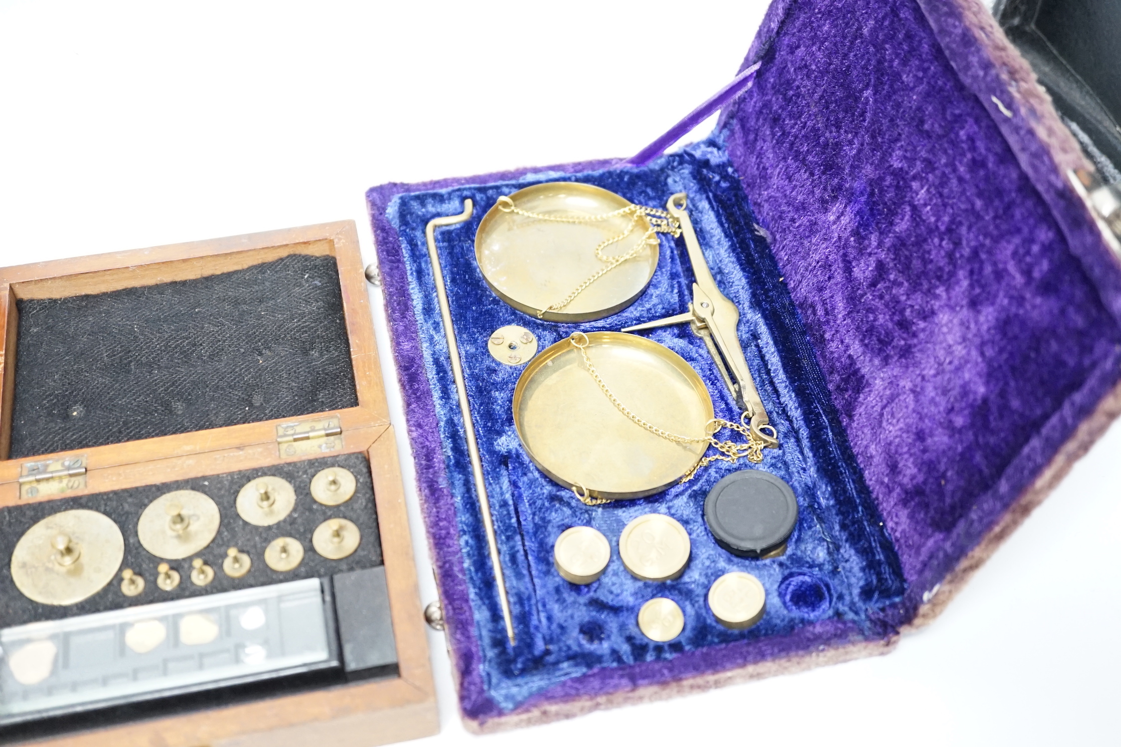 Four cased weighing sets, three of the sets with small scales included